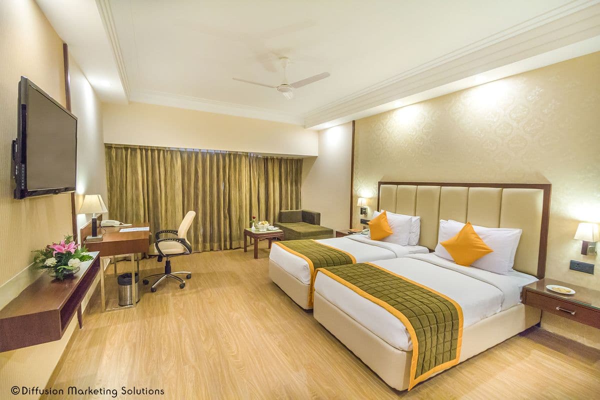 Spacious guest room with warm lighting at Kosayo Hotel